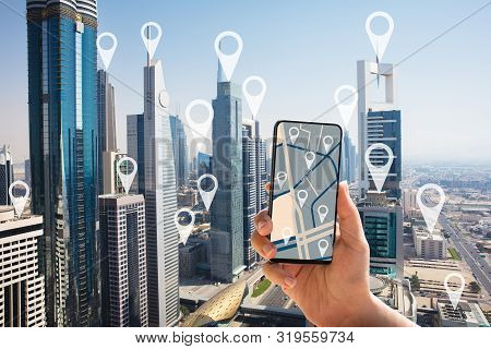 Tourist Using Gps Map Navigation Application On Smartphone Screen In Dubai City With Location Pointe
