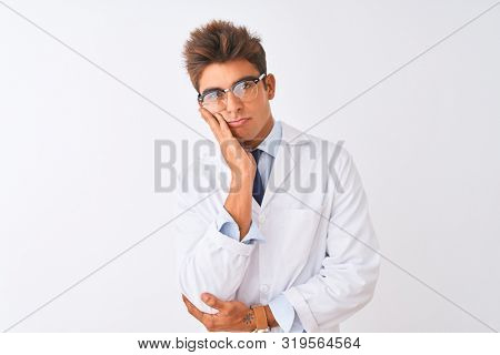Young handsome sciencist man wearing glasses and coat over isolated white background thinking looking tired and bored with depression problems with crossed arms.