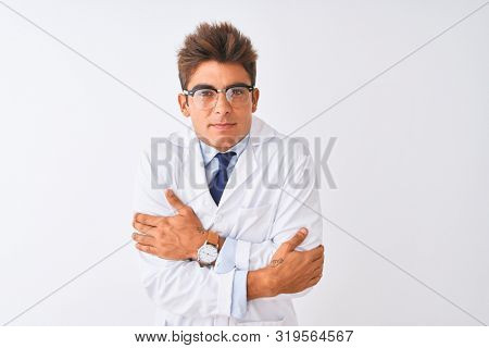 Young handsome sciencist man wearing glasses and coat over isolated white background shaking and freezing for winter cold with sad and shock expression on face