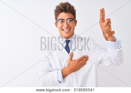 Young handsome sciencist man wearing glasses and coat over isolated white background smiling swearing with hand on chest and fingers up, making a loyalty promise oath