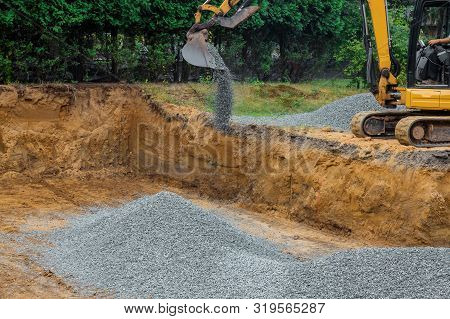 Backfilling Trench For The Gravel Stones At Construction Site In Excavator Backfill Of Foundation Di