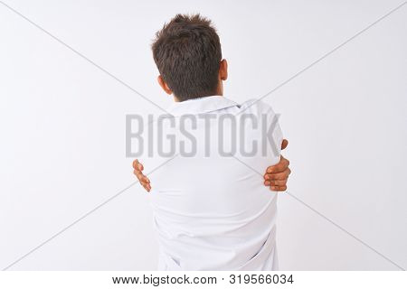 Young handsome sciencist man wearing glasses and coat over isolated white background Hugging oneself happy and positive from backwards. Self love and self care