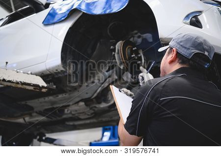 Asian Male Car Technician Car Maintenance For Customers According To Specified Vehicle Maintenance C