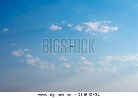 Silhouette Seaplane. Flying Boat On Blue Sky.