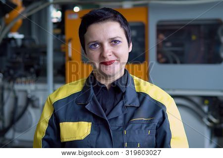 Portrait Of Female Engineer Operating Cnc Machinery In Factory