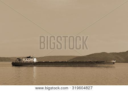 Cargo Ship Located On The Background Of The Mountains. At The Top There Is A Place For Your Text. Se