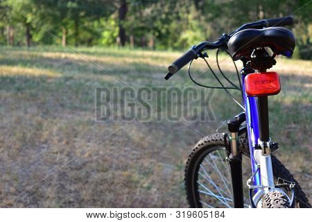 A Mountain Bike Is Located In A Forest Clearing. Place For Your Text. The Concept Of A Healthy Lifes