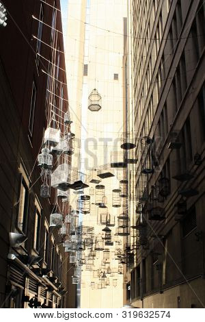 Many Bird Cages Hanging Between Two Buildings In Melbourne, Austrailia