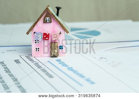 Mortgage Loan And Real Estate Property Concept : Mortgage Application Form With Driftwood Model Wood