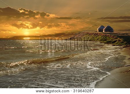 Fantastie Sunset Of Lartaudarkuk.sandi Beach Washed Bu The Wave And The Sun.yurts On A Steep Lank In