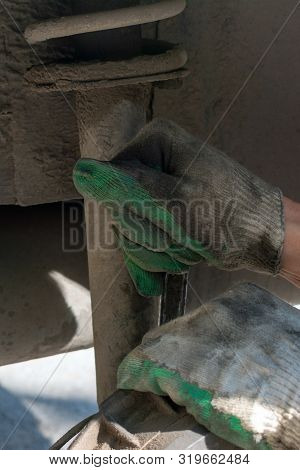 Hands In Defense Gloves Mechanics To Repair The Suspension On The Car. Work With A Wrench. Self-repa