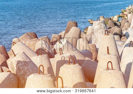 Breakwaters In Sea. Beautiful Sunset Seascape With Concrete Tetrapodes For Protect Coastal Structure