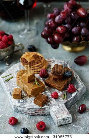 Norwegian Cheese Brunost On The Cutting Board .style Rustic.selective Focus