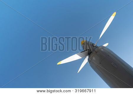Airplane Propeller Of Military Aircraft, Copy Space. Blue Sky Background.