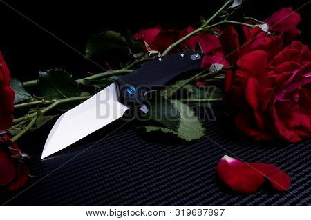 Knife And A Bouquet Of Flowers. Knife And Red Roses. Spicy And Prickly.