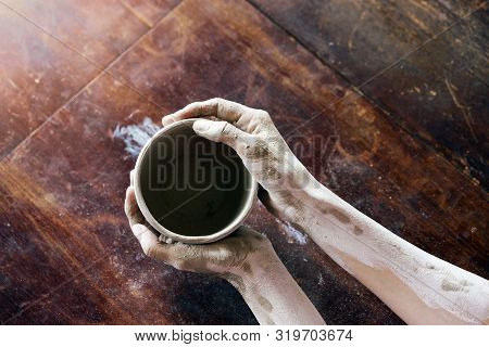 Female Hands Hold With A Wet Clay Bowl. Pottery Making