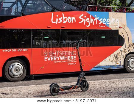 Lisbon, Portugal - 9 August 2019 - Circ Electric Scooter Waiting For Rental By Sightseeing Bus In Li