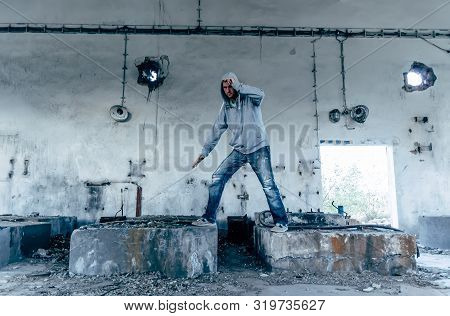 Portrait Of A Handsome Caucasian Hip Hop Dancer, Freestyling Outdoors In An Old Abandoned Building, 