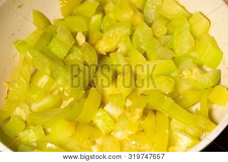 Chopped quash and bell pepper dish in white bowl. Close-up.