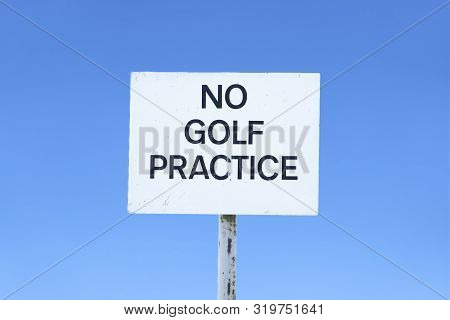 No Golf Practice Sign And Clear Blue Sky