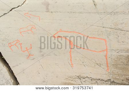 Rock Art In Alta Fjord, Norway. Ancient Symbols, Real Drawing,  Texture In Stone. Red Ocher Paint. H