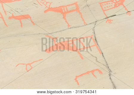 Rock Art In Alta Fjord, Norway. Ancient Symbols, Real Drawing,  Texture In Stone. Red Ocher Paint. H
