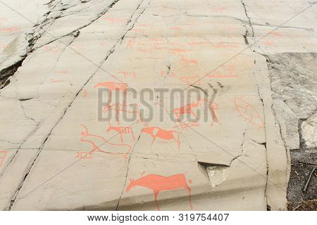 Rock Art In Alta Fjord, Norway. Ancient Symbols, Real Drawing,  Texture In Stone. Red Ocher Paint. H