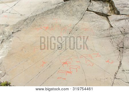 Rock Art In Alta Fjord, Norway. Ancient Symbols, Real Drawing,  Texture In Stone. Red Ocher Paint. H