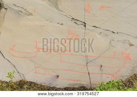 Rock Art In Alta Fjord, Norway. Ancient Symbols, Real Drawing,  Texture In Stone. Red Ocher Paint. H
