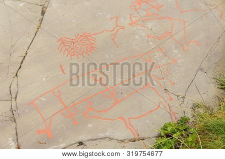 Rock Art In Alta Fjord, Norway. Ancient Symbols, Real Drawing,  Texture In Stone. Red Ocher Paint. H