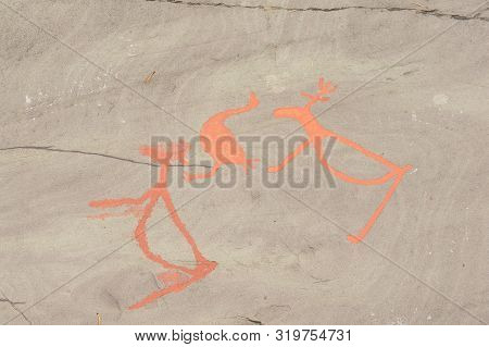 Rock Art In Alta Fjord, Norway. Ancient Symbols, Real Drawing,  Texture In Stone. Red Ocher Paint. H