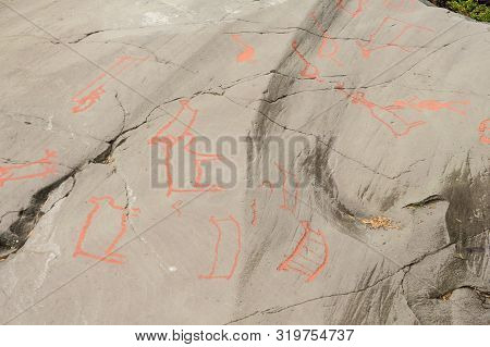Rock Art In Alta Fjord, Norway. Ancient Symbols, Real Drawing,  Texture In Stone. Red Ocher Paint. H