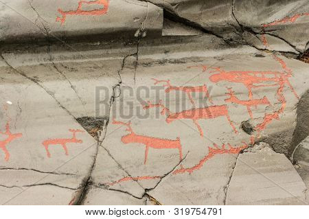 Rock Art In Alta Fjord, Norway. Ancient Symbols, Real Drawing,  Texture In Stone. Red Ocher Paint. H