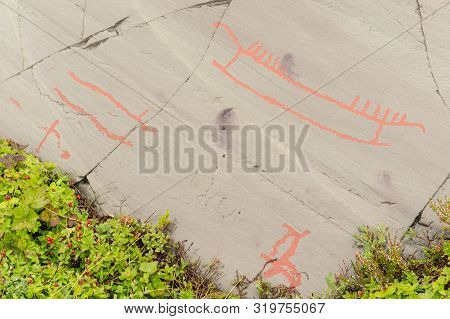Rock Art In Alta Fjord, Norway. Ancient Symbols, Real Drawing,  Texture In Stone. Red Ocher Paint. H