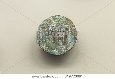 Merida, Spain - December 20th, 2017: Bronze Dupondius Depicting Merida Roman City Door. National Mus