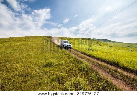 Primorye, Russia - August 2, 2018: Mitsubishi Pajero Goes Down The Hill By Dirt Road