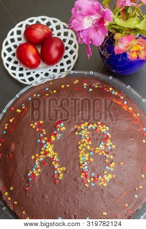 Chocolate Easter Cake With The Inscription Xb And Painted Eggs