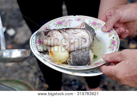Boiled Catfish Head. Fried Fish On A Plate. Pour Food Into A Plate.