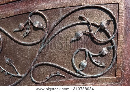 Elements Of Decorative Floral Ornament In A Metal Wrought Fence.