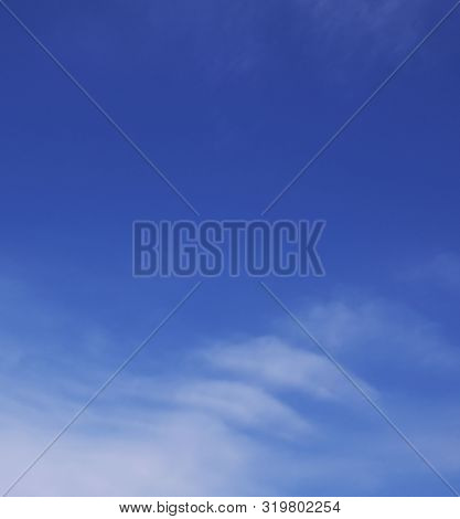 White Cloud Detail In Blue Sky. Background With Copy Space.