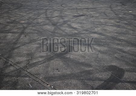Tire Tracks. Wheel Track On Asphalt Road. Asphalt With Traces Of Car Wheels. Traces Of Braking From 
