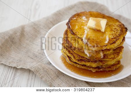 Homemade Corn Meal Johnny Cakes  On A White Plate On A White Wooden Table, Side View. Copy Space.