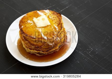 Homemade Corn Meal Johnny Cakes On A White Plate On A Black Background, Side View. Copy Space.