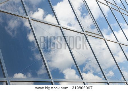 Angular View Of Glass Building View With Sky Reflection.