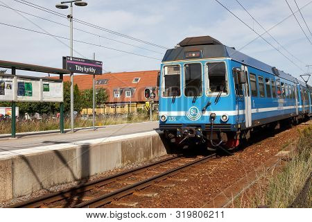 Taby Kyrkby, Sweden - August 30, 2019: A Blue Narrow Gauge Commuter Ttrain In Service On The Roslags