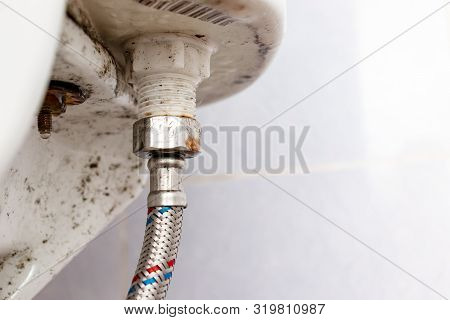 Water Supply Fitting Of Cistern Tank Of The Toilet Bowl At Water Closet Close Up