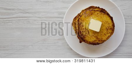 Homemade Corn Meal Johnny Cakes  On A White Plate On A White Wooden Surface, Top View. Flat Lay, Fro