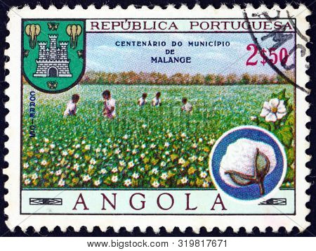 Angola - Circa 1970: A Stamp Printed In Portuguese Angola Shows Cotton Boll And Cotton Field, Arms O