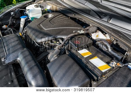 New Engine Compartment In The Car, Visible Parts Of The Engine, Cables, Lines And Reservoirs For Liq