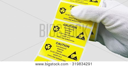 Hand Holding Esd Symbol Label With Antistatic Gloves On Gray Background,electrostatic Sensitive Devi